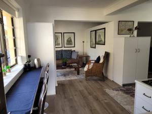 a living room with a table and a couch at Cowes Cottage in Fish Hoek