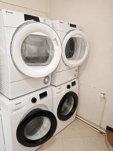 two washing machines are stacked on top of each other at Hostel Bed&Coffee 360° in Belgrade