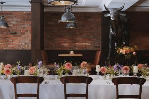 a table with flowers and a statue of a bull at Fermain Valley Hotel in St. Peter Port +65 photos