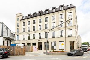 a large white building on the corner of a street at Global Living Passau Ludwigplatz in Passau