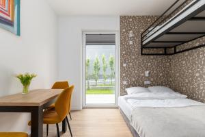 a bedroom with a bed and a desk and a table at ToTuLokum in Krakow
