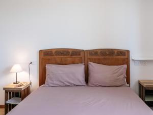 a bedroom with a large bed with two pillows at Agriturismo Le Crede 1930 in Portogruaro