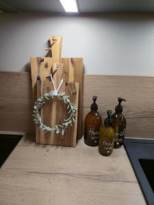 a shelf with three bottles on a table at Ferienhaus Frida in Kleinich
