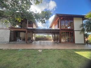 a large house with a large deck in front of it at Flats Theo Peleteiro Praia da concha Flatitacareconcha in Itacaré