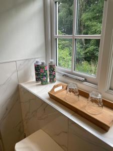 a bathroom counter with two glasses and a window at Thorn Tree Garth in Coulton +13 photos