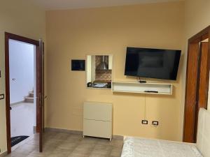a living room with a flat screen tv on the wall at Shengjin Central Apartments in Shëngjin