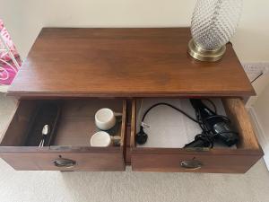a wooden table with a lamp in a wooden drawer at Thorn Tree Garth in Coulton
