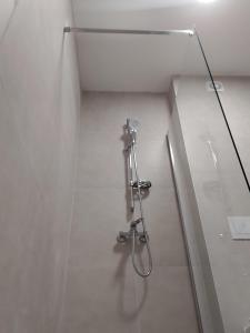 a shower in a bathroom with a glass wall at Apartman Ika 2 in Kruševo +32 photos