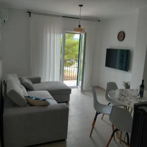a living room with a couch and a table at Apartman Ika 2 in Kruševo