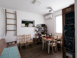 a dining room with a table and chairs and a chalkboard at Agriturismo Le Crede 1930 in Portogruaro