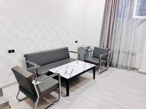 a living room with a couch and chairs and a table at Regal Hotel in Kapan