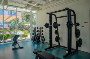 a gym with several treadmills and weights at Aesthetic Kings Studio at Uptown Al Zahia Sharjah in Sharjah