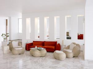 a living room with a couch and chairs and a table at Grecotel Casa Adele in Platanes