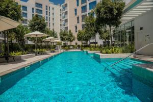a swimming pool in the middle of a building at Aesthetic Kings Studio at Uptown Al Zahia Sharjah in Sharjah +16 photos