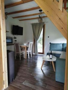 a living room with a couch and a table at Durmitor Forest Retreat in Žabljak