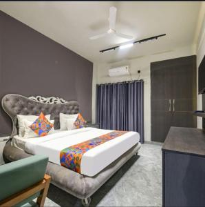 a bedroom with a large bed and a couch at Luxury Hotel Aura Residency in Rāiwāla