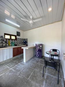 a room with a table and a chair in it at Bale Baleku Homestay in Praya +21 photos