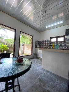 a dining room with a table and a counter at Bale Baleku Homestay in Praya