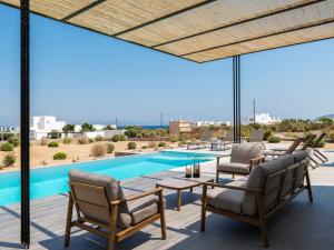 a patio with chairs and a swimming pool at Villa Sabbia in Mesochórion