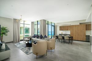 a living room with a couch and a table at Charthouse Bahrain in Manama