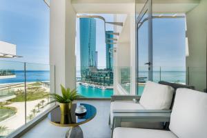 a living room with a view of the ocean at Charthouse Bahrain in Manama