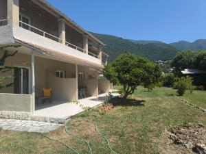 a house with a patio and a tree at Alexandros and Georgia in Ipsos