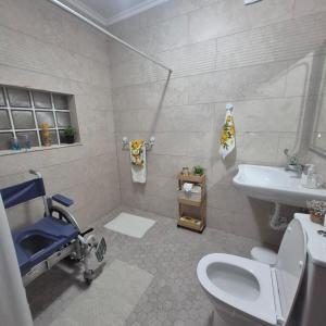 a white bathroom with a toilet and a sink at Peaceful Retreat in Mosteiros +14 photos