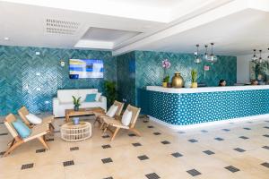 a living room with a couch and a table and chairs at CDSHotels Le Castella - Ninfe Saracene in Le Castella