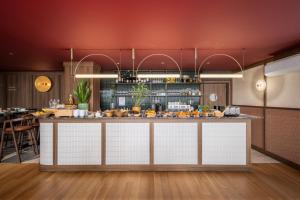 a kitchen with a large island in a room at Casa Falcão Boutique Hotel by Aspasios in Porto +23 photos