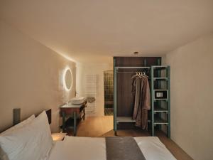 a bedroom with a bed and a desk and a closet at Stuveles Apartments in Brixen