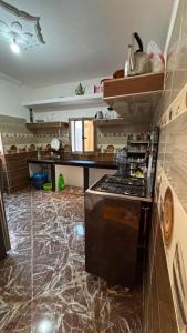 a kitchen with a stove and a counter top at Sidi kaouki Private House in Sidi Kaouki