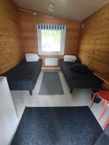 a small room with two beds and a window at Arctic Camping Finland in Pello +43 photos