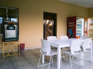 a white table and white chairs in a room at Seven Elements Resort in Ras al Khaimah