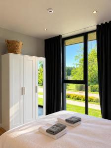 a bedroom with a bed with two towels on it at SIA Green Guest House in Sigulda