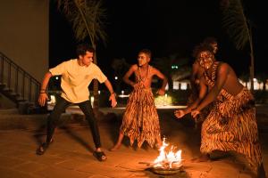 a group of people dancing around a fire at Vanam at Sasan in Sasan Gir