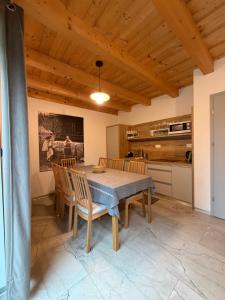 a kitchen and dining room with a table and chairs at Chata ŠENKÁRKA Zuberec in Zuberec