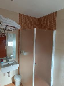a bathroom with a shower and a sink at Casa Alonso in Narón