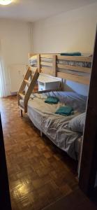 a bedroom with two bunk beds and a wooden floor at Iglica Apartments - First Floor in Bohinjska Bela