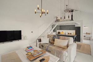 a living room with a couch and a table at The Village Barn in Caniço