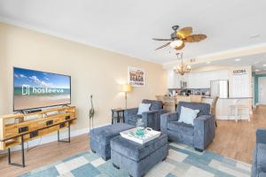 a living room with couches and a flat screen tv at San Carlos 1503 in Gulf Shores +46 photos