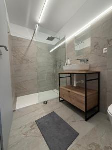 a bathroom with a sink and a shower at Chata ŠENKÁRKA Zuberec in Zuberec +20 photos