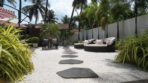 a patio with a couch and some stepping stones at Kamah, Goa in Anjuna