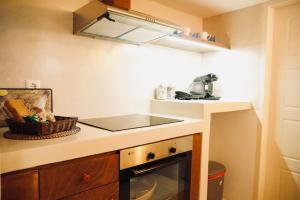 a small kitchen with a sink and a counter top at Case De Drymona 1 in Kythira