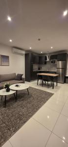 a living room with a couch and a table at The Loxwood Premier Suites in Accra