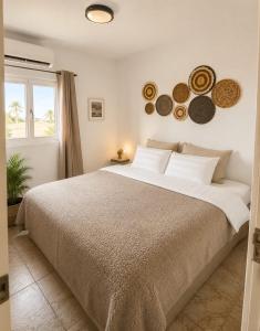 a bedroom with a large bed and a window at Island Vibes Apartment in Noord