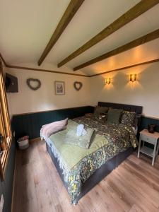 a bedroom with a large bed in a room at The Coach House or The Shepherd Hut in Blackpool