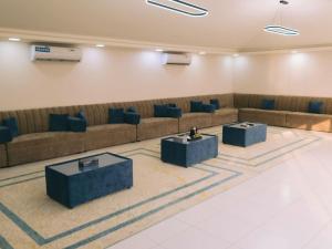 a waiting room with couches and tables in a building at Palm Escape Farmhouse - By Seven Elements in Ras al Khaimah +66 photos