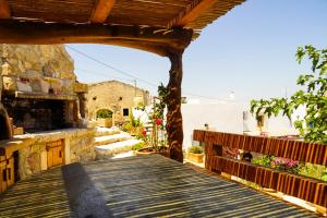 a wooden walkway leading to a building with a building at Case De Drymona 1 in Kythira