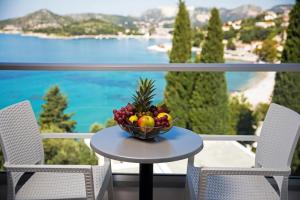 a bowl of fruit on a table on a balcony at Maistra Select Astarea Hotel in Mlini