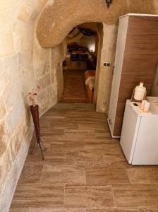 a hallway of a room with a kitchen and a refrigerator at Cappadocia Cave House in Ürgüp